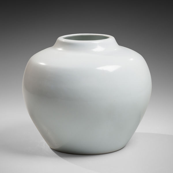 Rounded white vessel with slightly slanted shoulders and short, raised mouth