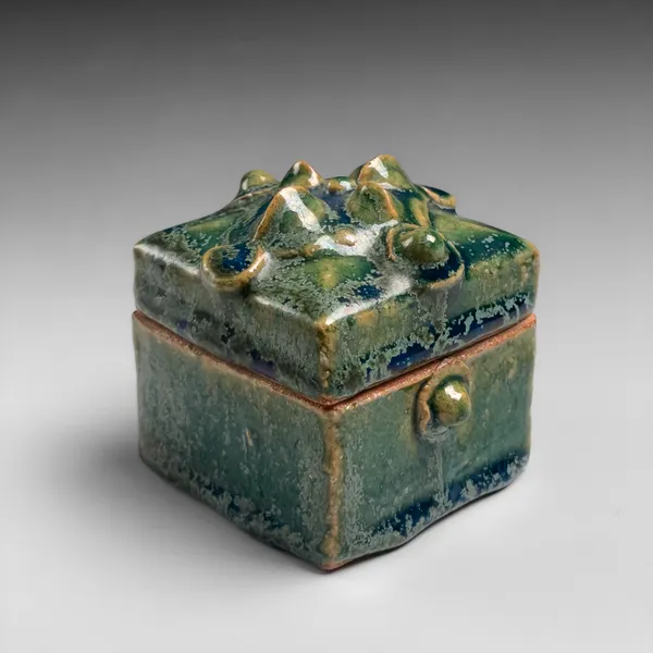 KAWAI KANJIRŌ, Square lidded container with green glaze and raised flower motif, ca. 1962