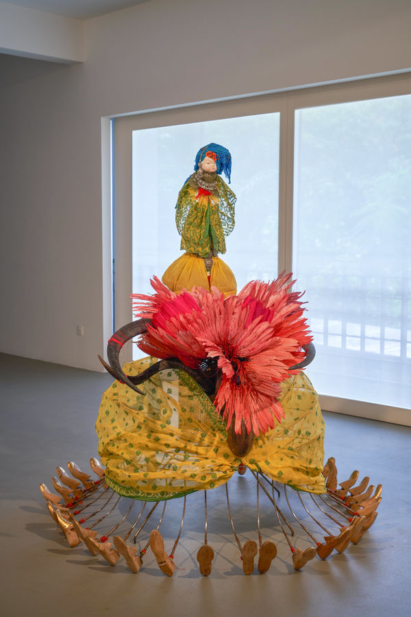 Rina Banerjee Preternatural passage came from wet whiteness and mercantile madness, paid for circular migrations, she went thirty six directions that is all the more different, where empire threw her new born and heritage claimed as well, this lady bug was not scarlet , 2011 Steel armature, vintage porcelain baby doll head, wooden spindle, cowrie shells, red thread, vintage birch wood shoe form (size 9-10), Bengali saree, feathers, horns, costume wedding jewelry H164 x W151 x L160 cm