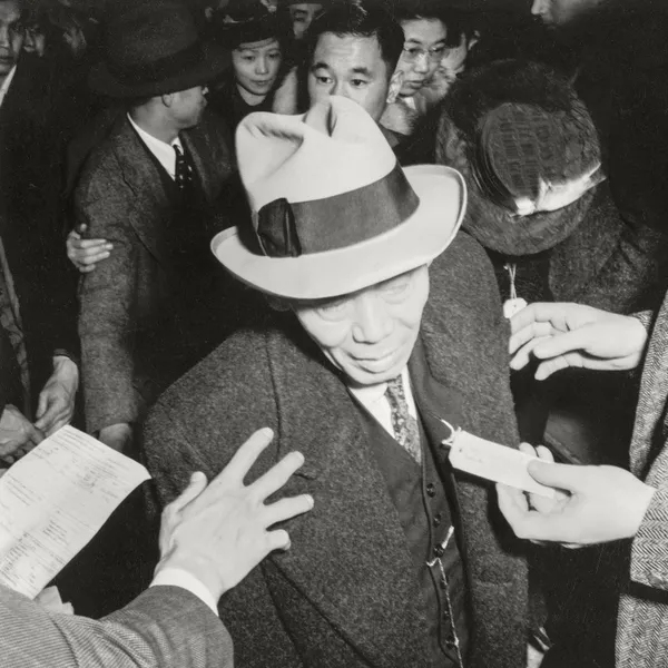 Just about to step into the bus for the Assembly Center - Photograph by Dorothea Lange, 1942