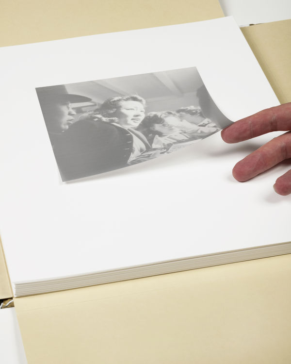 Girls of Japanese ancestry have just sighted a Greyhound bus which will take them to an Assembly center - Photograph by Dorothea Lange, 1942