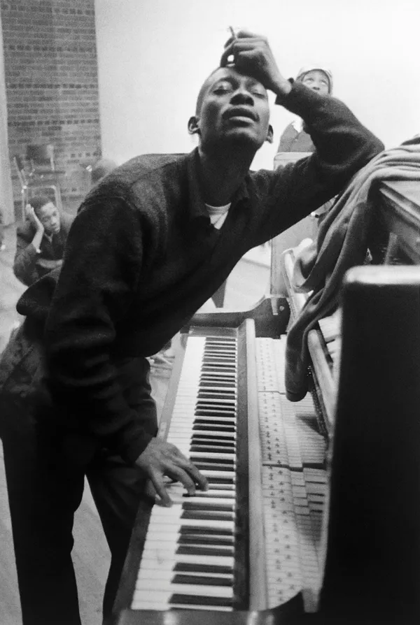 Alf Kumalo, Gideon Nxumalo closes his eyes as he caresses the piano keys and holds a cigarette at a rehearsal, Soweto, c.1960s
