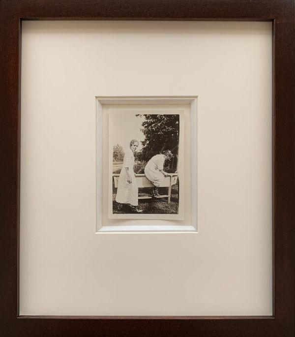 John Latour, Two Women in White Dresses and Black Boots, One Climbs over a Curious Structure, 2021