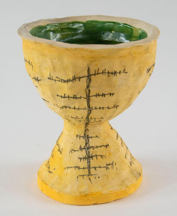 A sculpture of a chalice decorated with an image of a telephone pole by artist Reniel Del Rosario.
