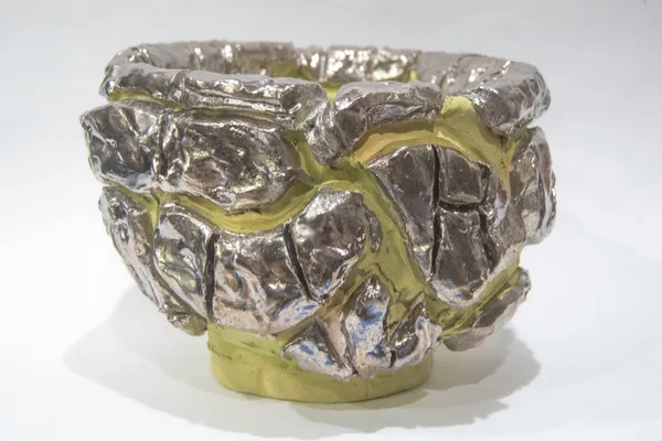 A bowl consisting of silver and green fragments by artist Reniel Del Rosario.