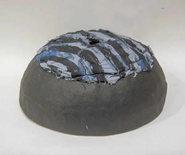 A sculpture of a black and blue loaf of bread by artist Reniel Del Rosario.