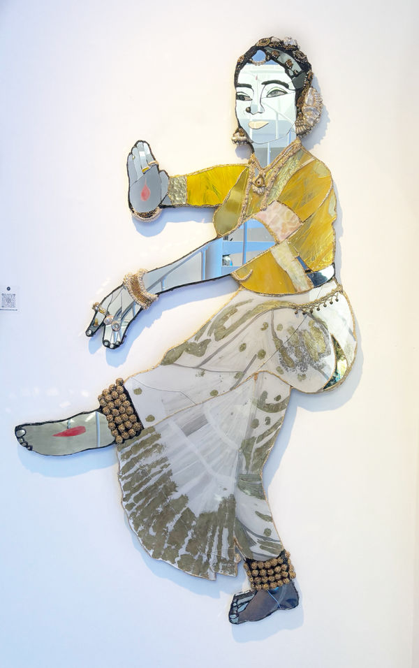 Colourful, unique mirrored sculpture by Andrew Logan, capturing movement of a traditional Indian dancer.