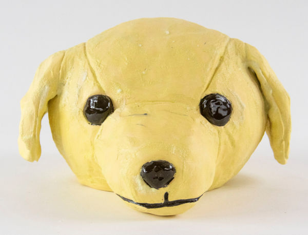 A sculpture of a dog head by artist Reniel Del Rosario.