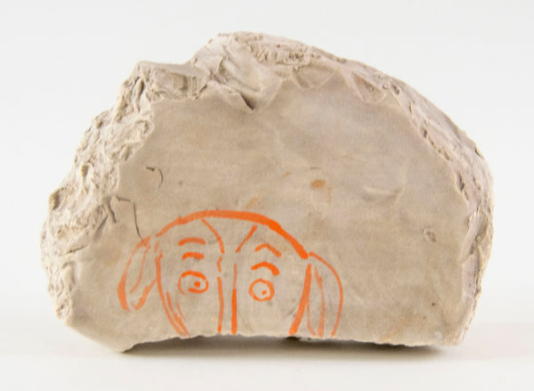 A slab with the top half of a lamb's head painted on it by artist Reniel Del Rosario.