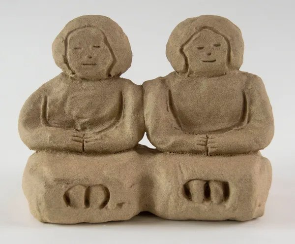 A sculpture of two figures sat side by side by artist Reniel Del Rosario.