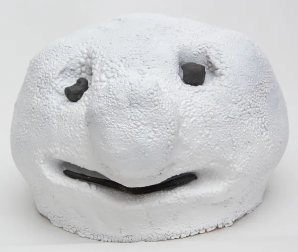 A sculpture of a snowball with two eyes and a mouth by artist Reniel Del Rosario.