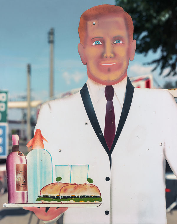 Jim Dow, Detail of Sign of Waiter Carrying Drinks and a Sandwich, Alta Gracia, Cordoba, Argentina, 1989