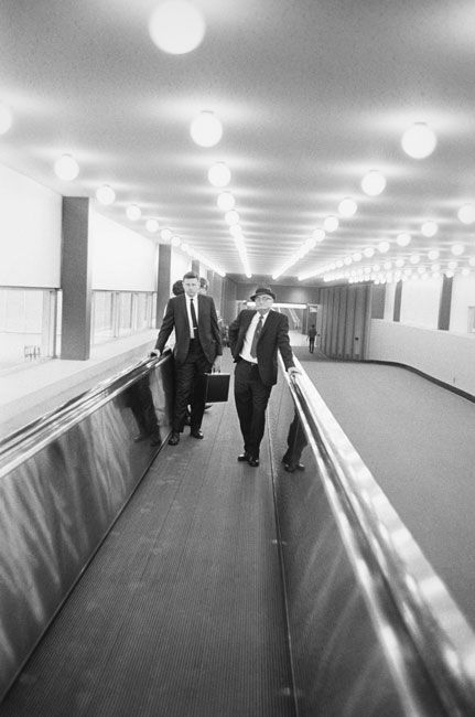 William Eggleston, Untitled, (business men on conveyor), 1960-1972