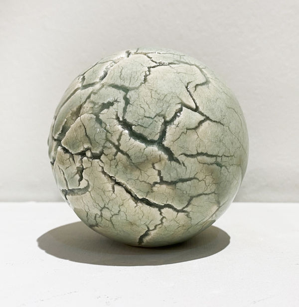 Clare Flatley Planetary Bodies VI, 2021 Porcelain, iron glaze 10 cm diameter