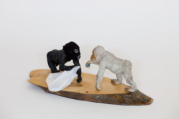Josephine Cachemaille Got a light?, 2009 Paint, stocking, thread, wood, glue, metal, plastic, found plastic apes and found souvenir wood 120 x 300 x 100 mm