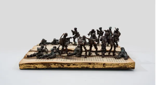 Kingsley Gunatillake Noperalena Pitu 12, 2026 Old Book, Gold Leaf and Copper Figures 17 x 22 x 6 cm 7 x 8 5/8 x 2 3/8 in