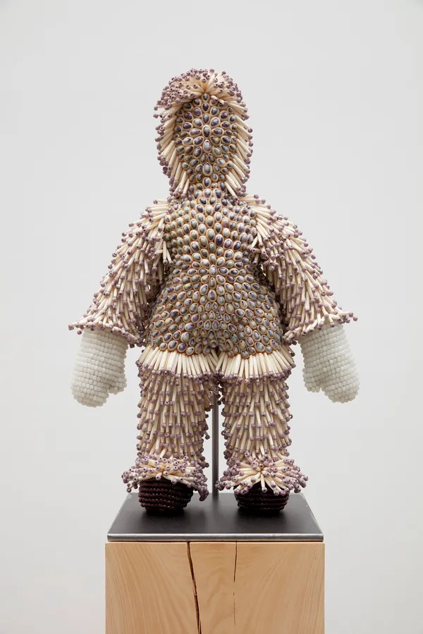 Jeffrey Gibson foni hicha hakshup, 2020 Acrylic Felt, Fiber Fill, Cowrie Beads, Artificial Bone Beads, Steel Rod, Glass Beads, Pine Resin, Nylon Thread, Polyester Fiber Fill, Steel Support, Wood Base 31 x 21 x 8 inches (78.7 x 53.3 x 20.3 cm) 74 3/8 x 21 x 13 5/8 inches (188.9 x 53.3 x 34.6 cm), overall with base and stand [Base: 42 7/8 x 13 1/2 x 13 5/8 inches (108.9 x 34.3 x 34.6 cm)]