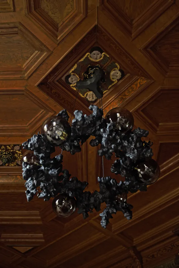 Tadeáš Podracký Risen From The Ashes Chandelier, 2023 Charred spruce wood, black glass floral details, blown glass elements, brass fittings