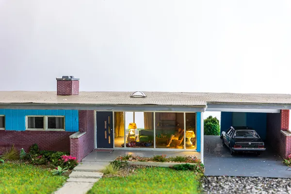 miniature diorama by Abigail Goldman of a naked woman sitting inside a house next to dead bodies