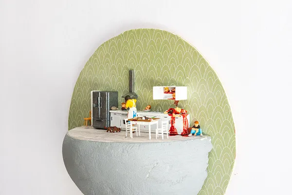 miniature diorama by Abigail Goldman of a woman cooking in her kitchen with severed body parts