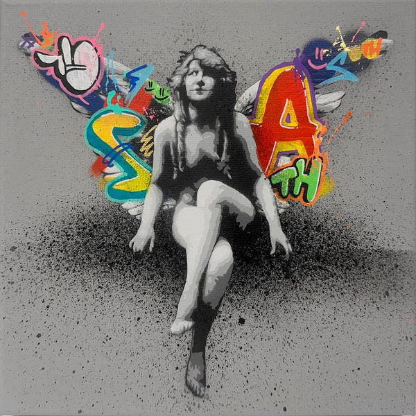 seated woman painted in black and white with colorful graffiti butterfly wings