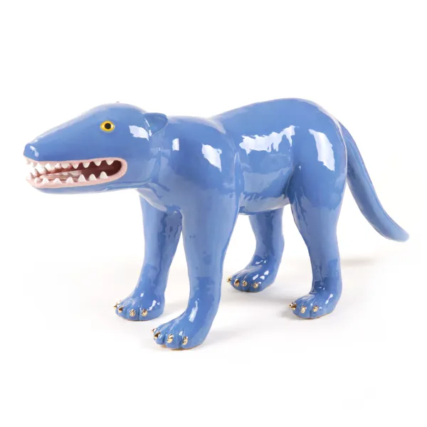blue ceramic sculpture of a four legged prehistoric creature