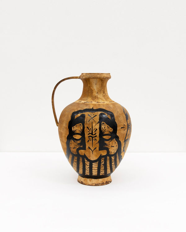 GATS character painted on a metal brown vase in black