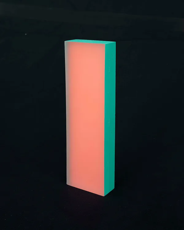Rachel Strum - epoxy neon sculpture of vertical rectangle strip - orange and Turkish green.