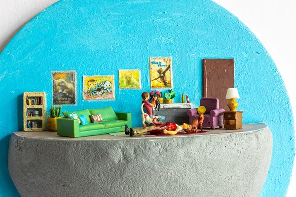 miniature diorama by Abigail Goldman of a woman and her three cats next to a bloody dead man