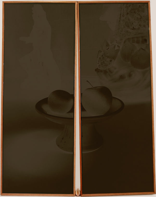 Wooden frame bisected by wooden hinge, stretched black fabric with black imprint of fruit bowl