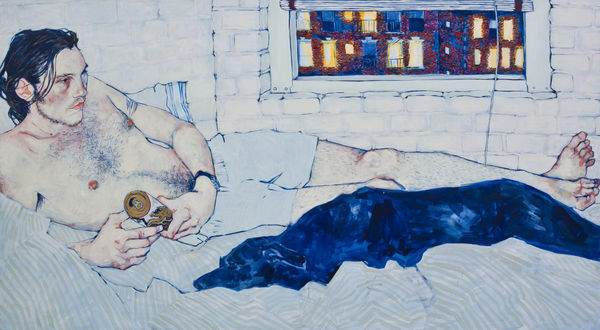 Portrait of a man reclining in bed with a dark blanket