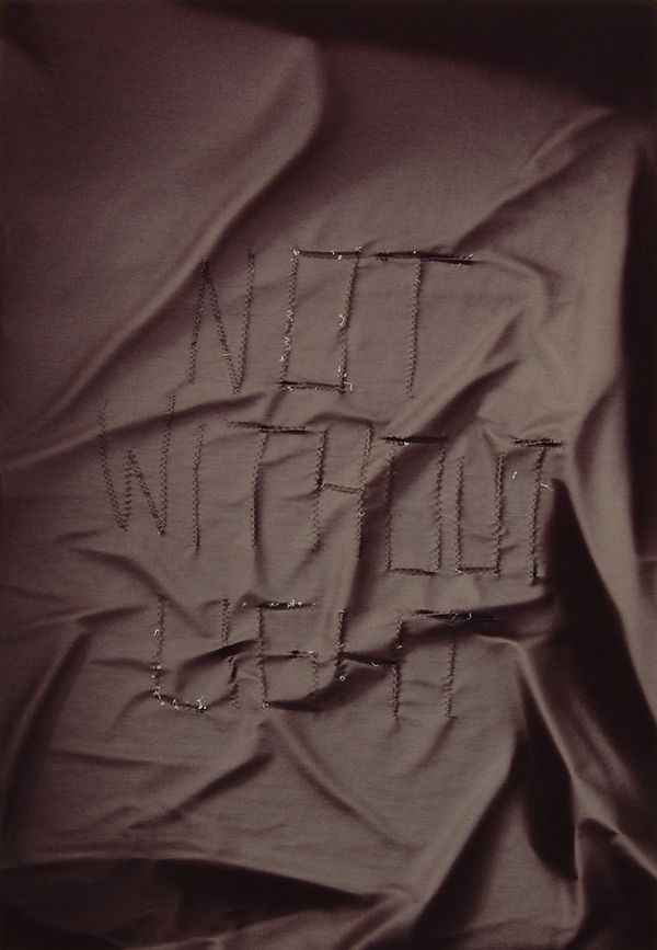 Black fabric with text "Not without light"