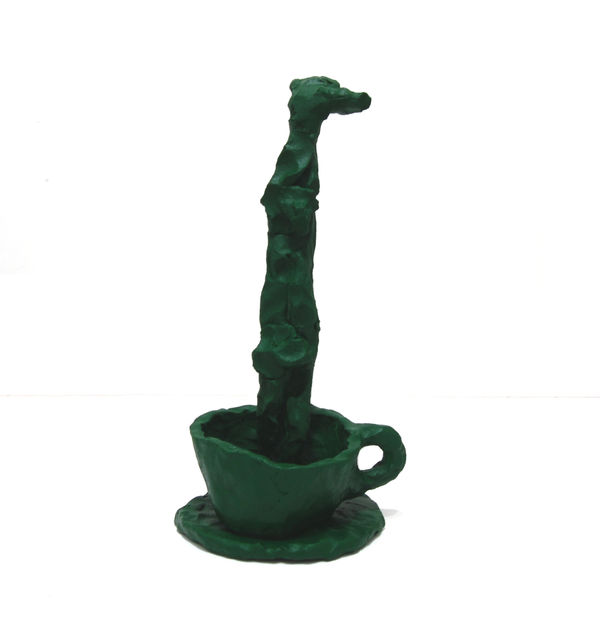 Ceramic cup containing vertical rod painted dark green