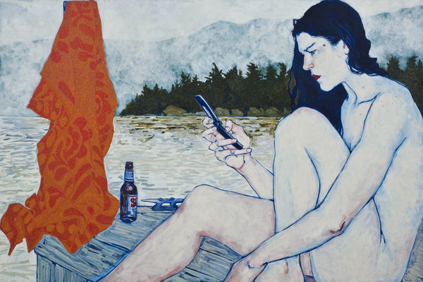Portrait of a nude woman looking at her phone