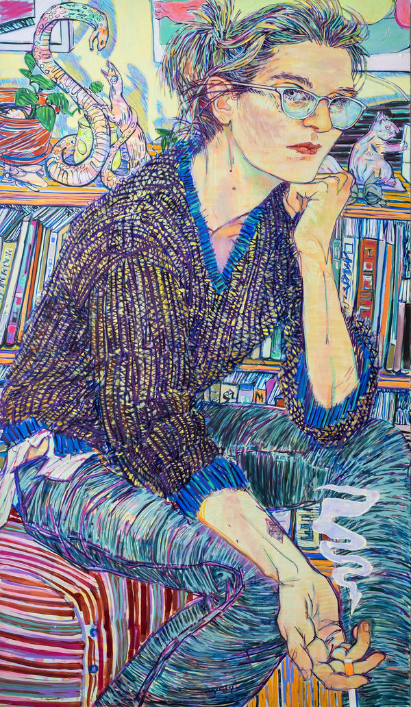 Woman wearing glasses sits with head resting on one hand