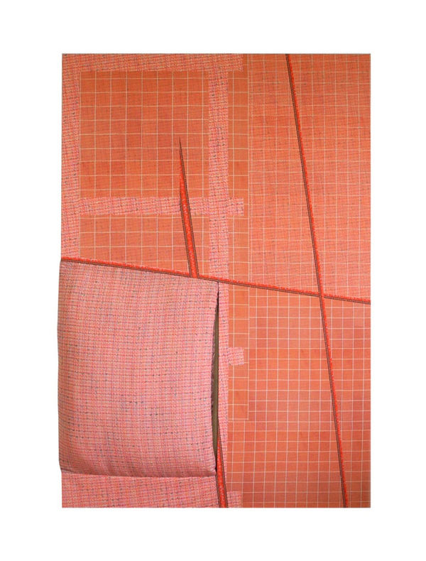 Stitched together fabric covered stretcher in red and pink pattern with multiple slits
