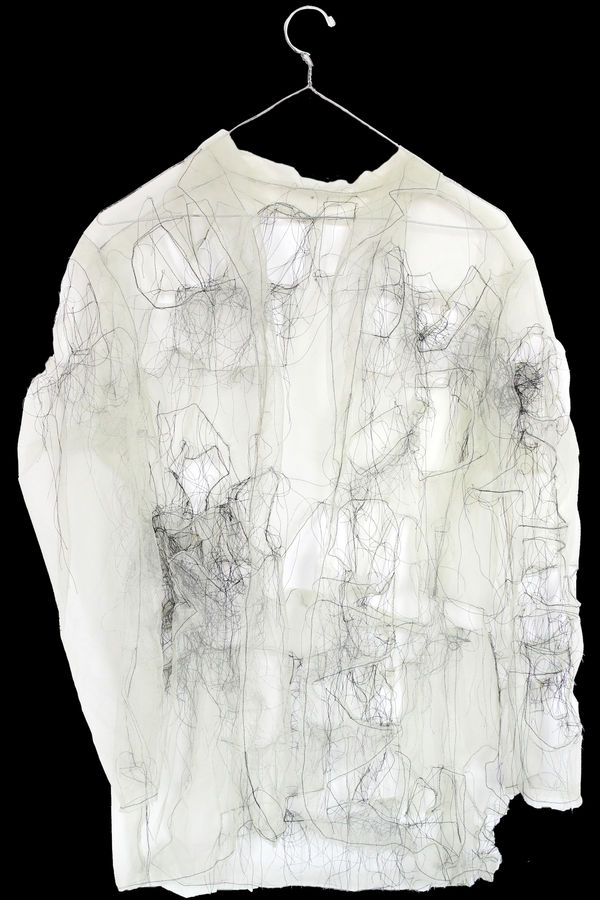 Jacket made of translucent fabric and black loose threads