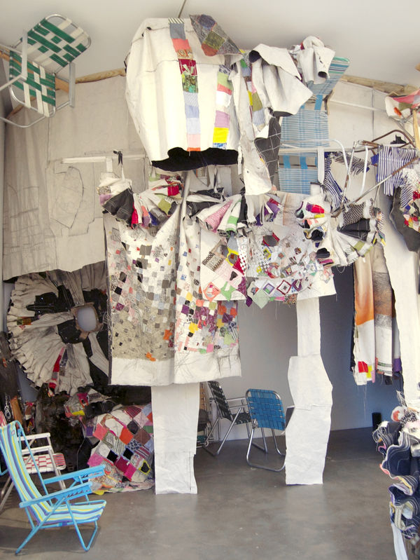 Canvas, colored pencil, fabric, gesso, graphite, hardware, lawn chair webbing, paper, spray paint, thread, wire, wood all hanging from the ceiling