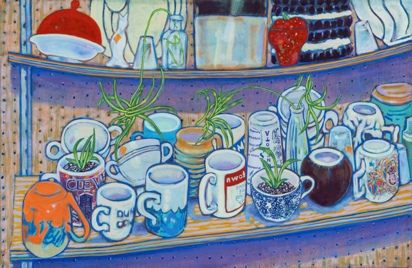 Tabletop piled with ceramic cups and mugs