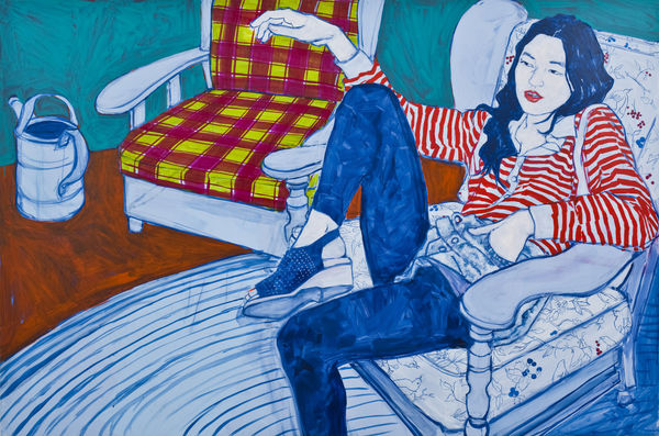 Portrait of a woman in a striped shirt sitting on a chair