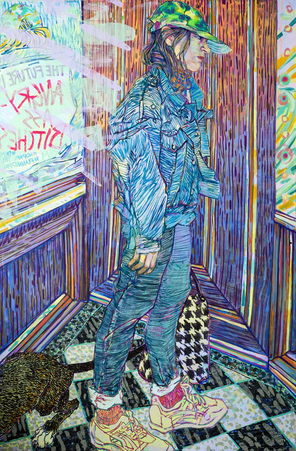 Woman wearing all denim and a green baseball hats stands in a corner