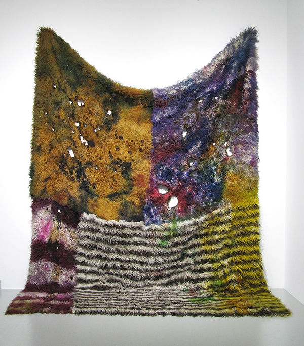 Colorful shaggy rug burned and dyed in deep purple and light orange