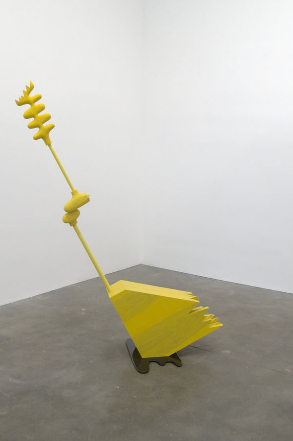 Carved wood abstraction stained yellow, triangular shape with long extension sitting in brown carved wood puddle