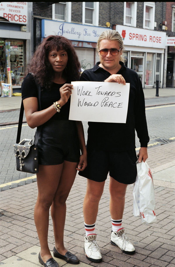 two people holding sign that says work towards world peace