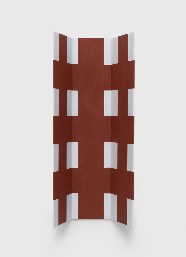 red and white sculpture on wall