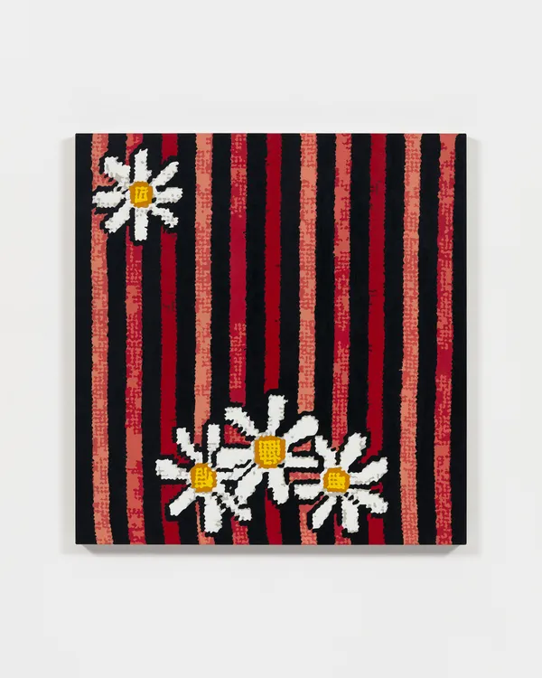 Striped needlepoint painting with daisys against white wall
