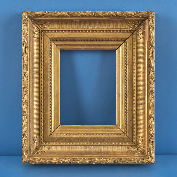 Orientalist fluted hollow frame, 19th century gilt compo, fluted hollow with acanthus mitre leaves; bound leaf and berry top; ribbon and stick; incised frieze; pearl; integral slip rebate size: 10.375 x 7.875 inches sight size: 9.5 x 7 inches width: 4.75 inches