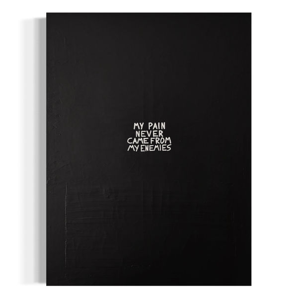 A vertical black and white typographic painting with the text "MY PAIN NEVER CAME FROM MY ENEMIES" hand-painted in white over a dark, heavily textured background of joint compound.