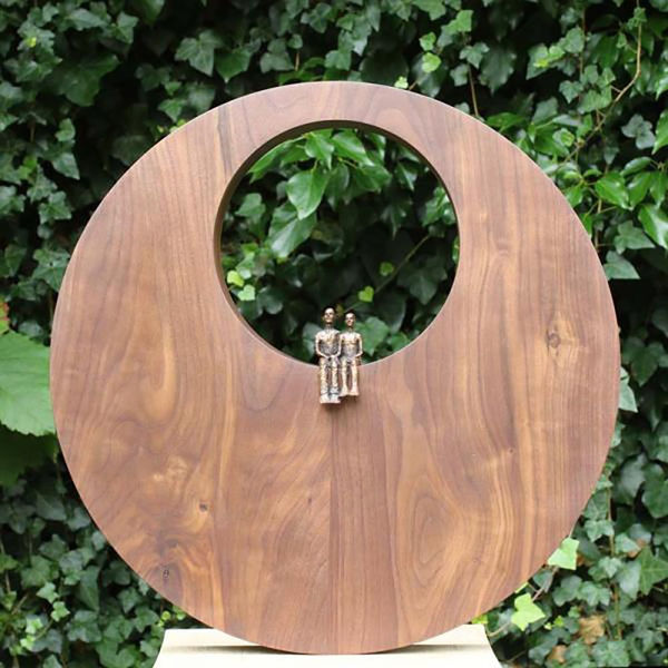 Carol Peace Place II, ed. 12/25 Bronze couple sitting in Walnut circle 16 x 16 x 2 "