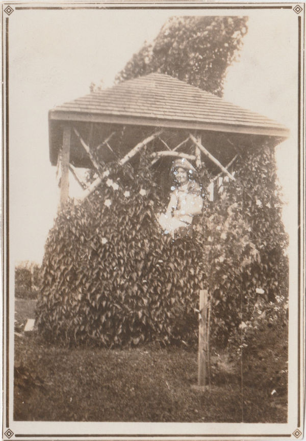 John Latour, Smiling woman with binoculars in tree house, 2024
